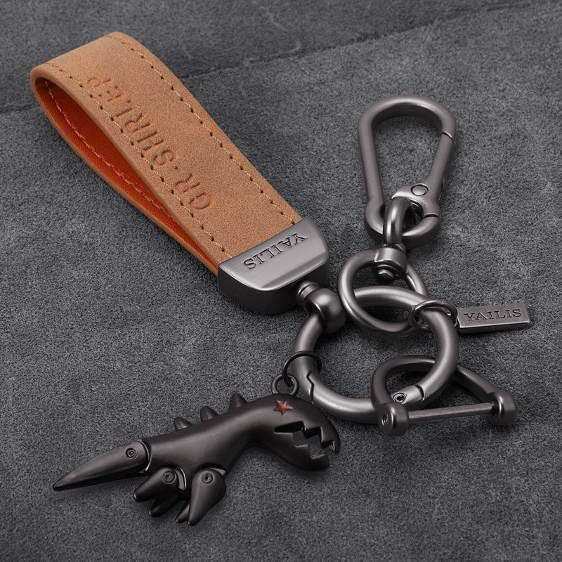 Porte-clés dinosaure en métal avec cordon en daim