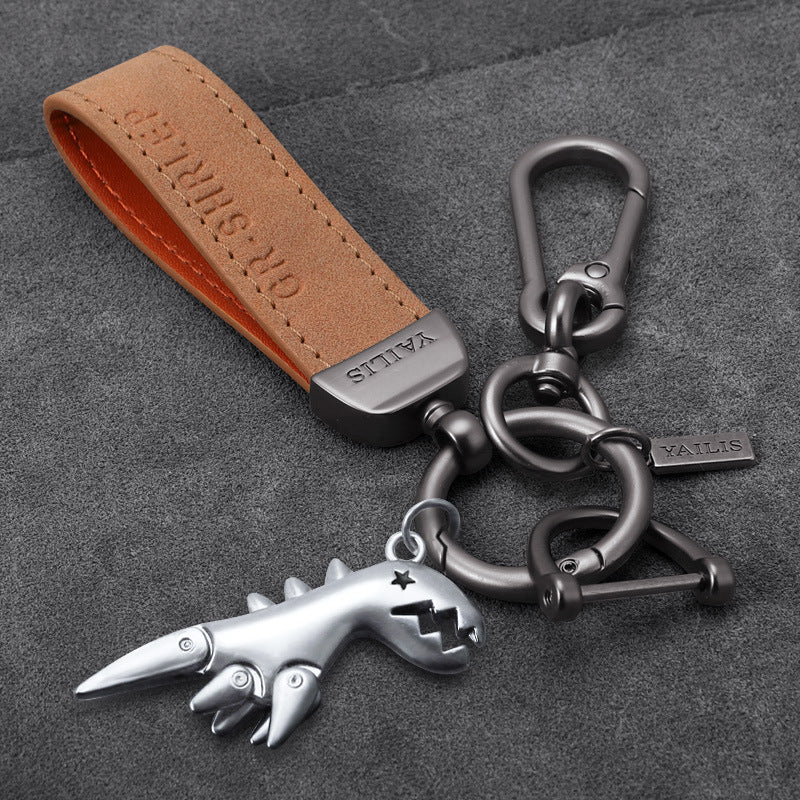 Porte-clés dinosaure en métal avec cordon en daim
