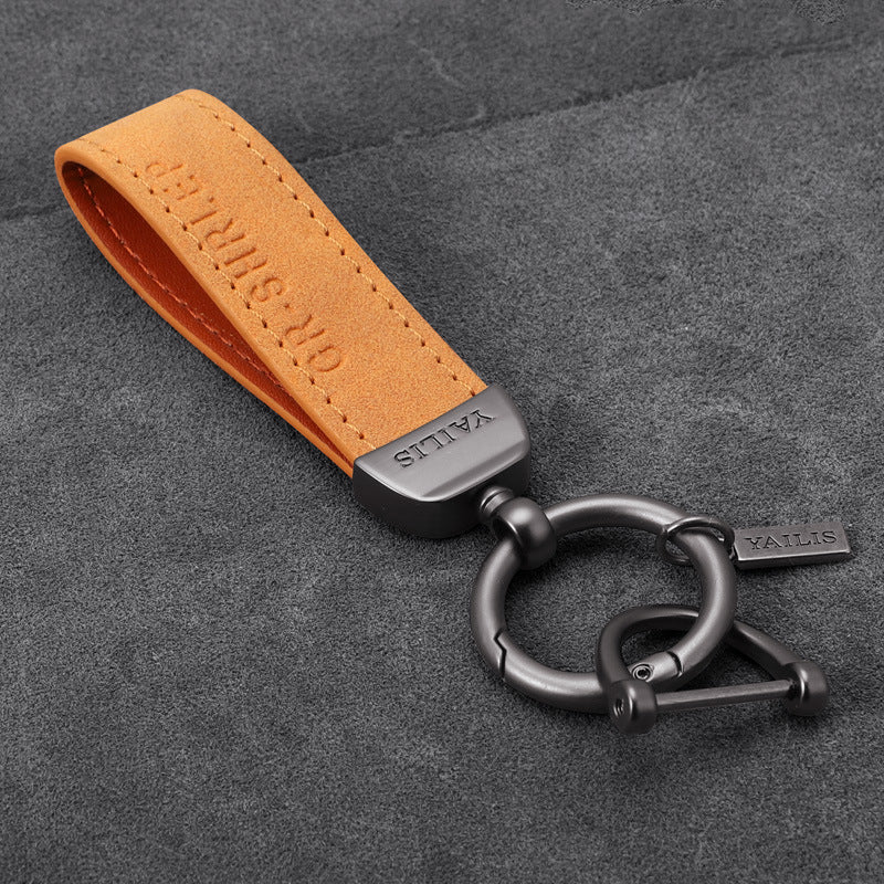 Porte-clés dinosaure en métal avec cordon en daim