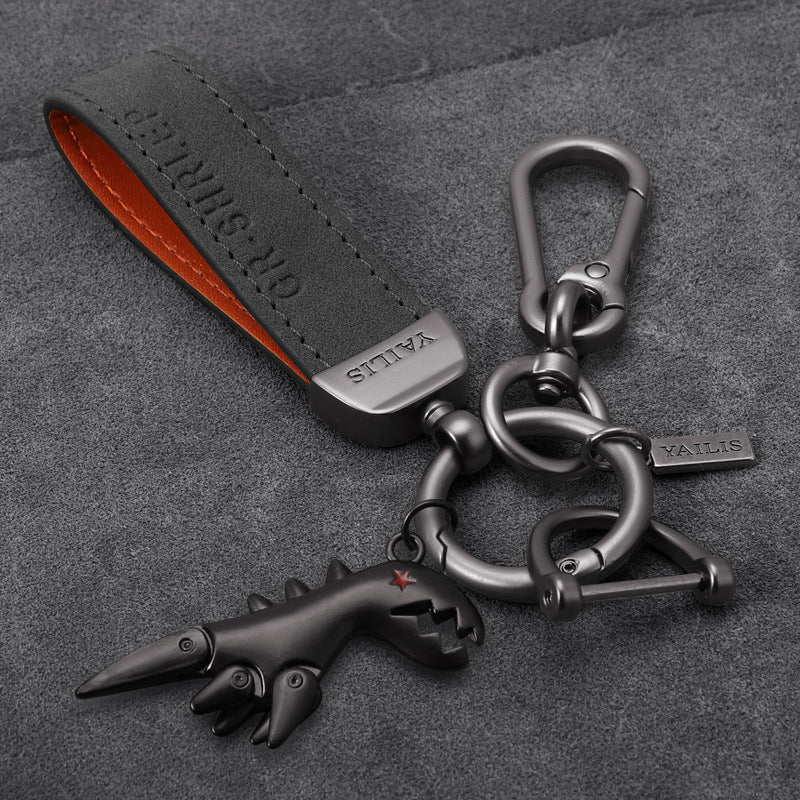 Porte-clés dinosaure en métal avec cordon en daim