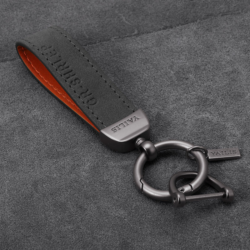 Porte-clés dinosaure en métal avec cordon en daim