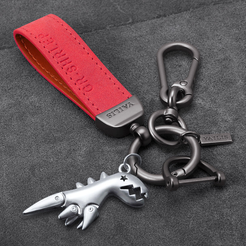 Porte-clés dinosaure en métal avec cordon en daim