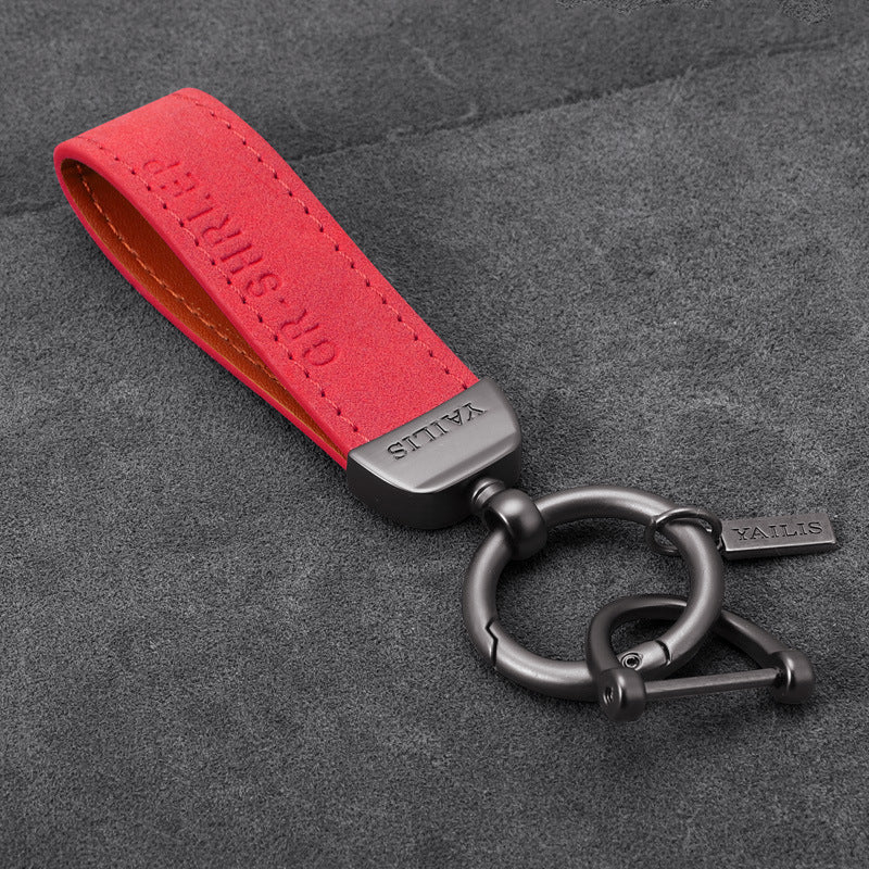 Porte-clés dinosaure en métal avec cordon en daim