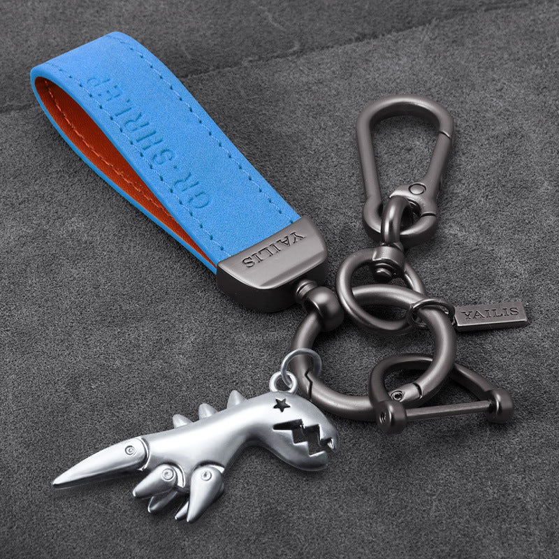 Porte-clés dinosaure en métal avec cordon en daim